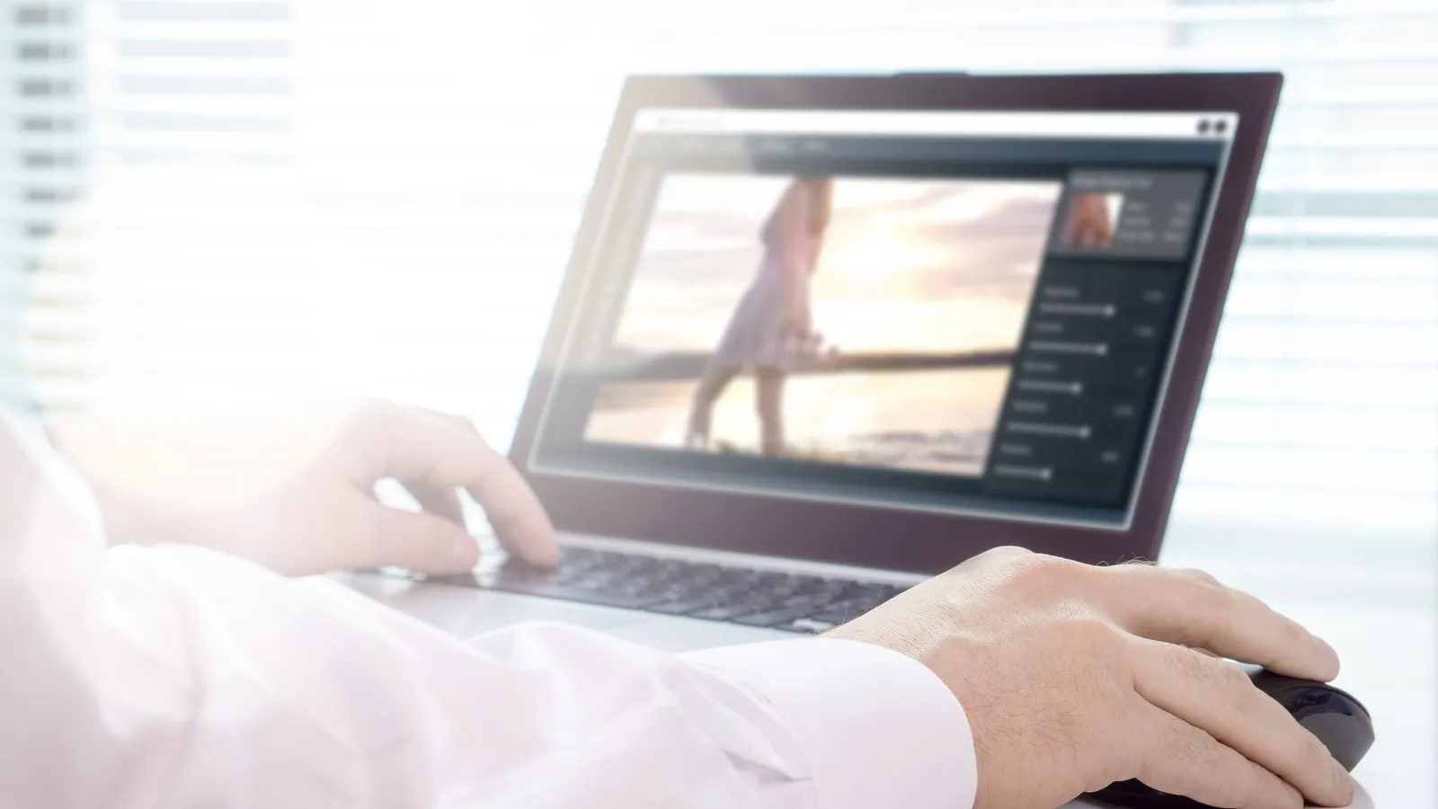 A photographer editing a photo on a laptop