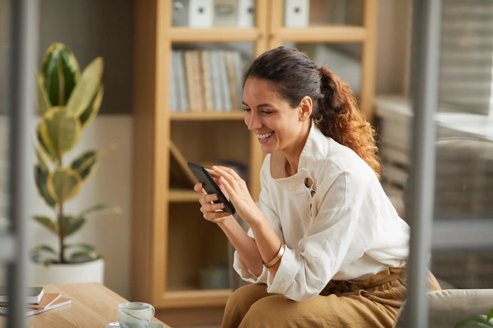 A client smiling at photos on her phone